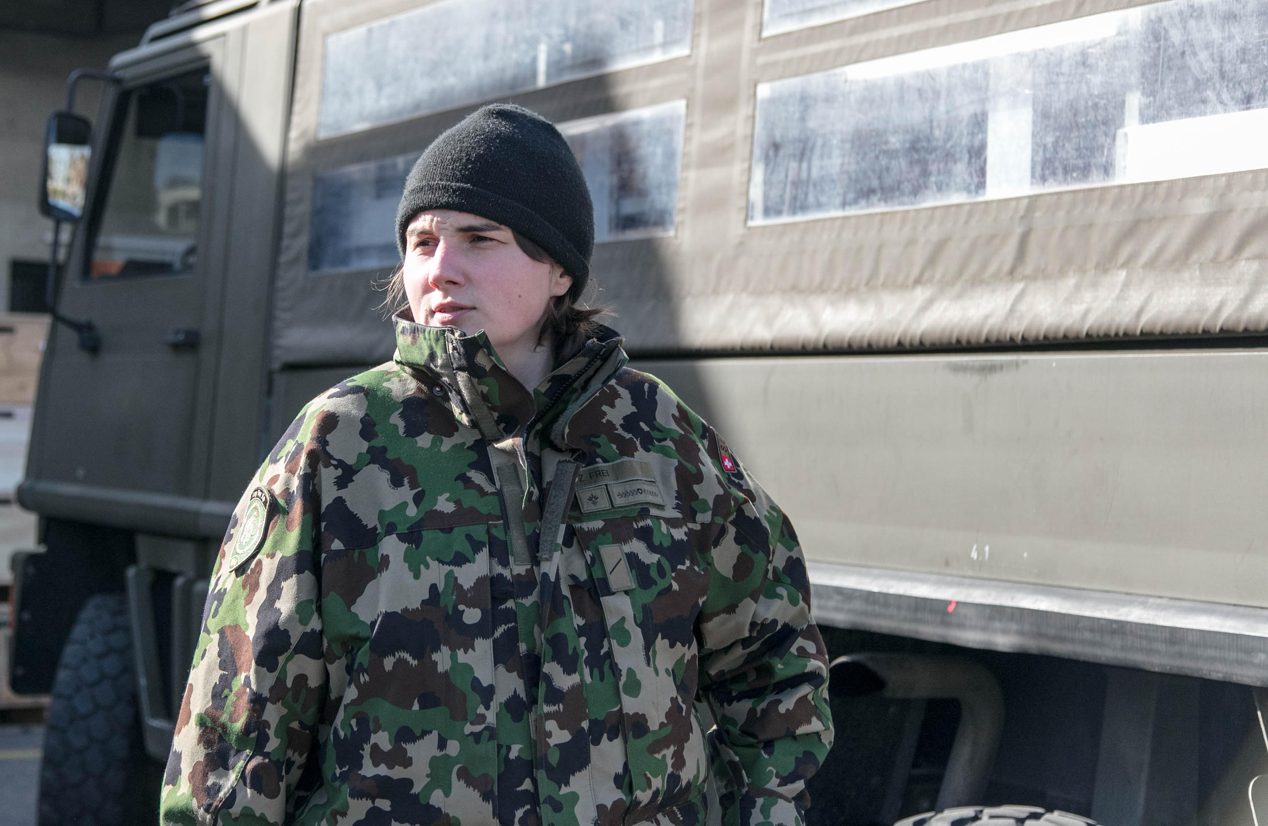 Private Zoé in front of a military vehicle