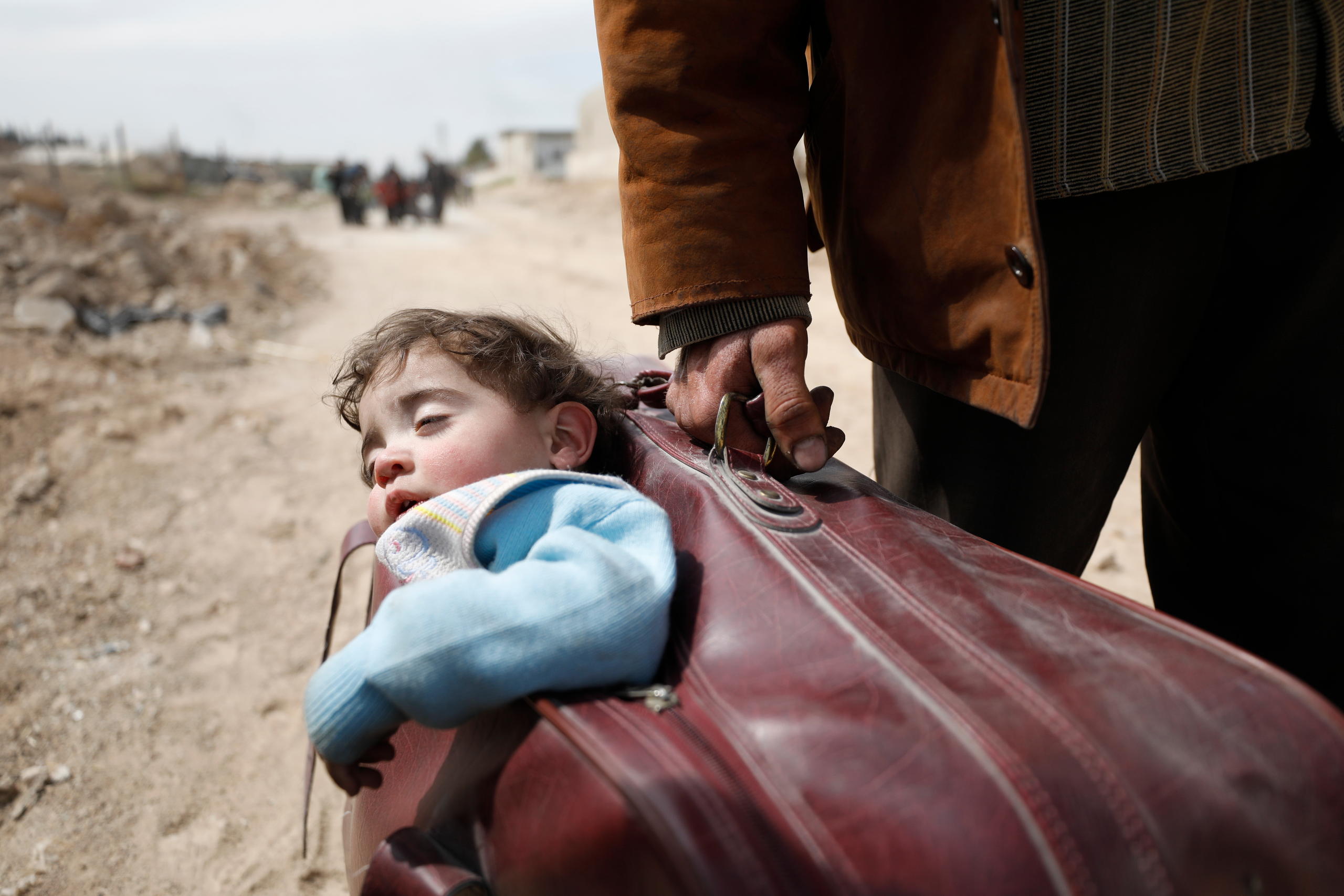 A child carried in a suitcase in Syria