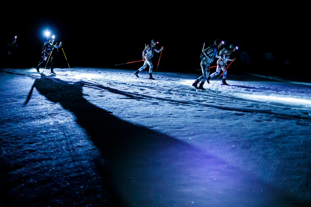 four men on a glacier at night