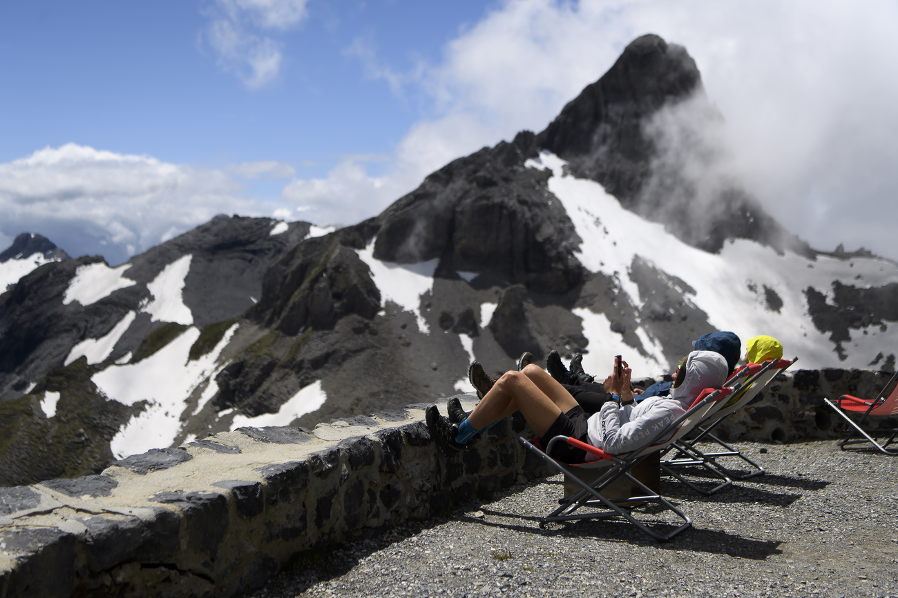 People relaxing by a mountain