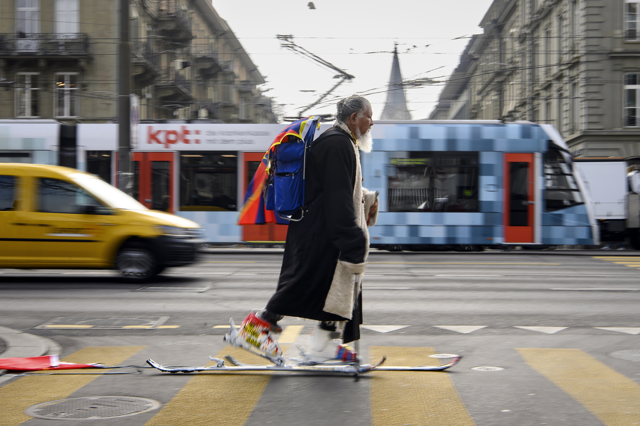 man walking on skis in city