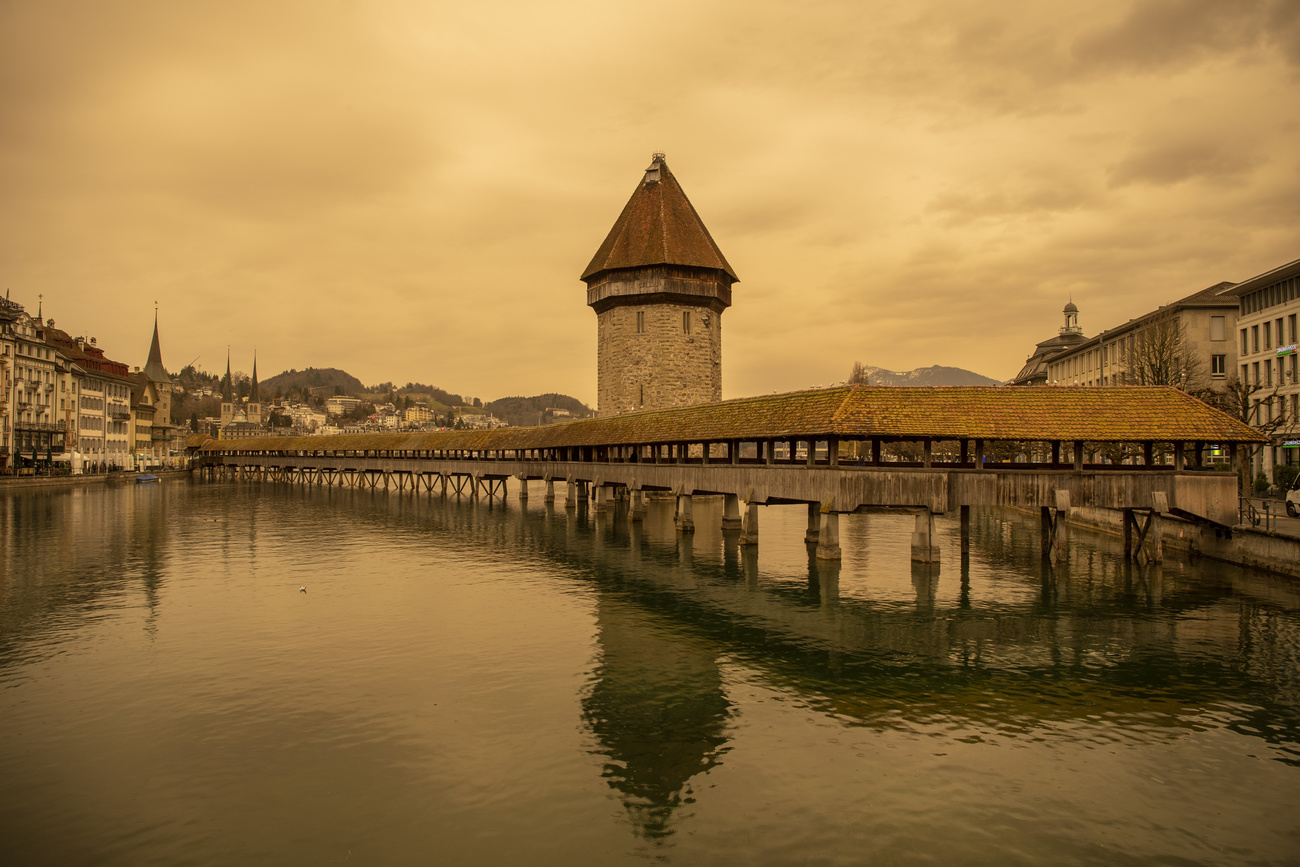 ochre sky over water and city