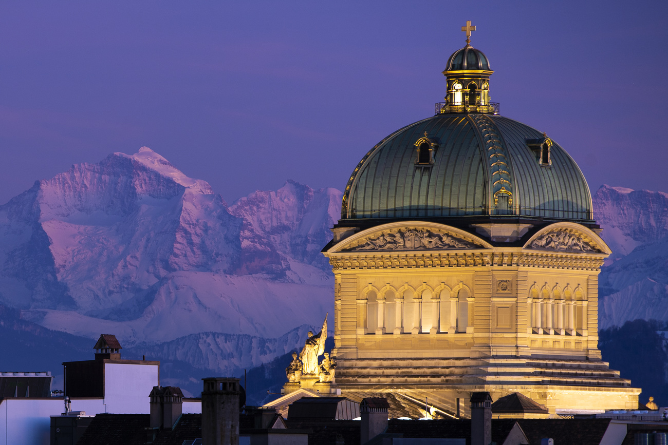 Swiss parliament building in Bern with mountain backdrop