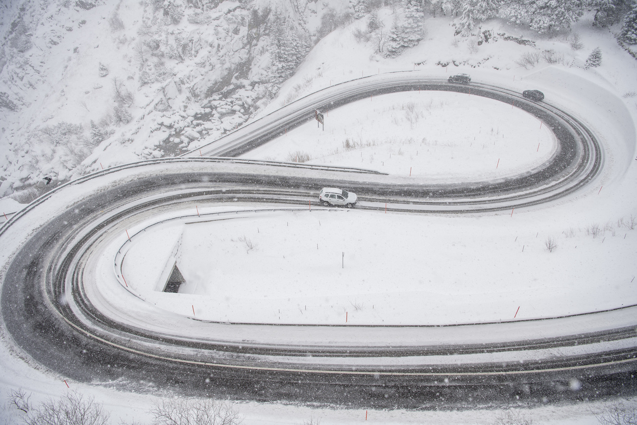 Car on snowy Swiss mountain pass