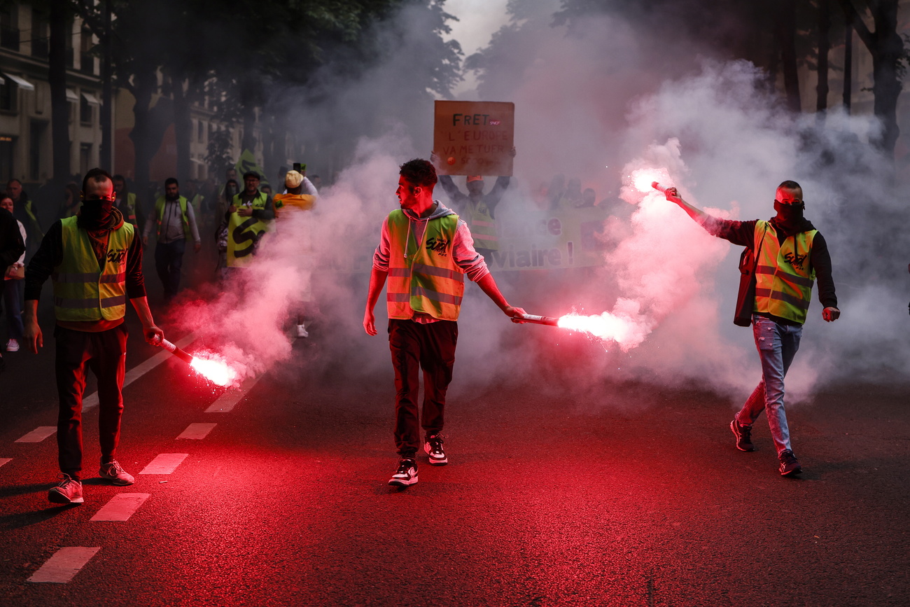 demonstrators with flares