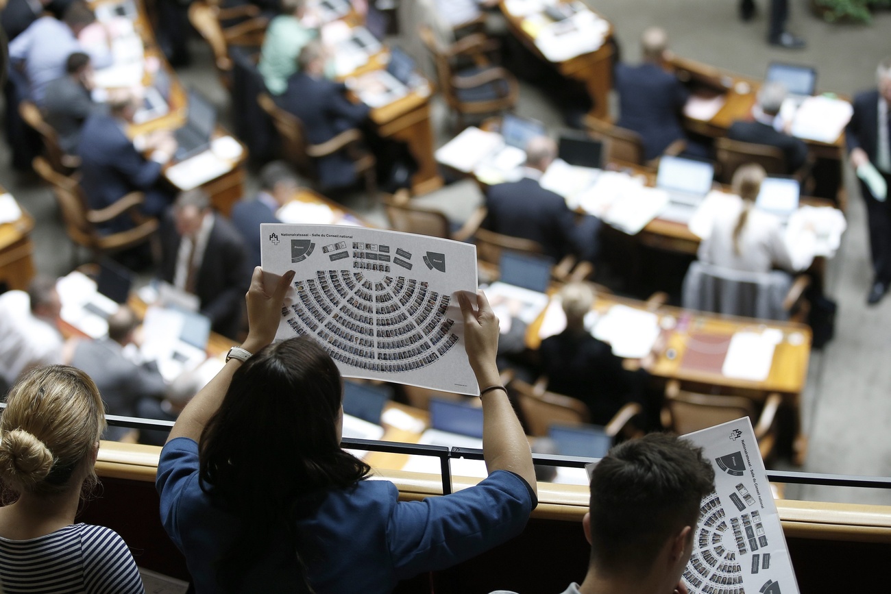 person observes a graph with parliamentary seats
