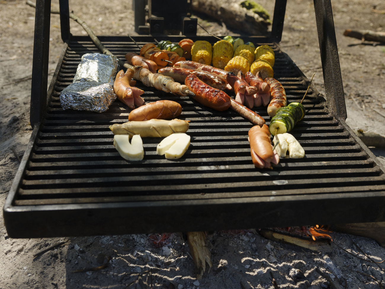 Carne e verdure su un grill all aperto.