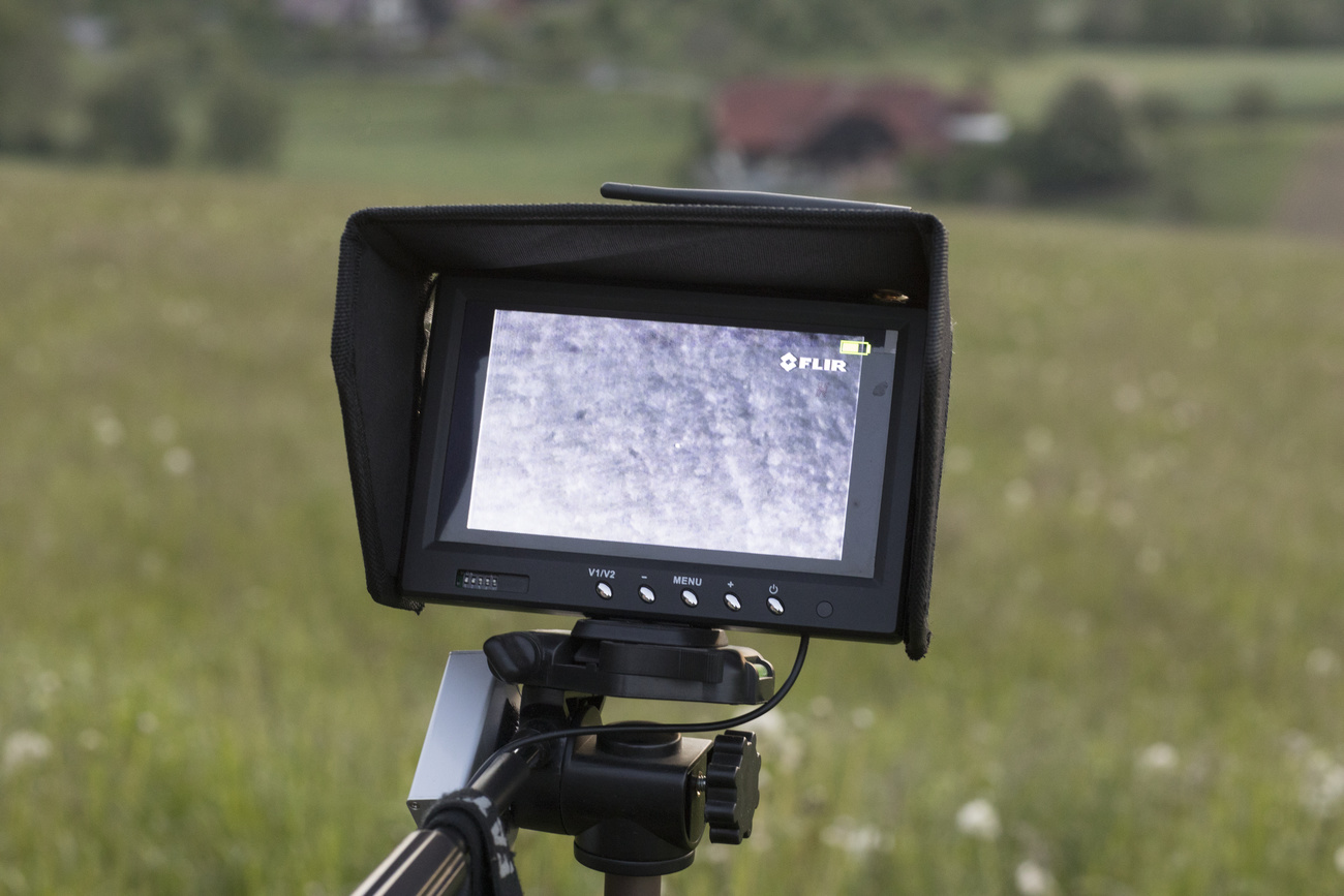 thermal camera set up in front of meadow