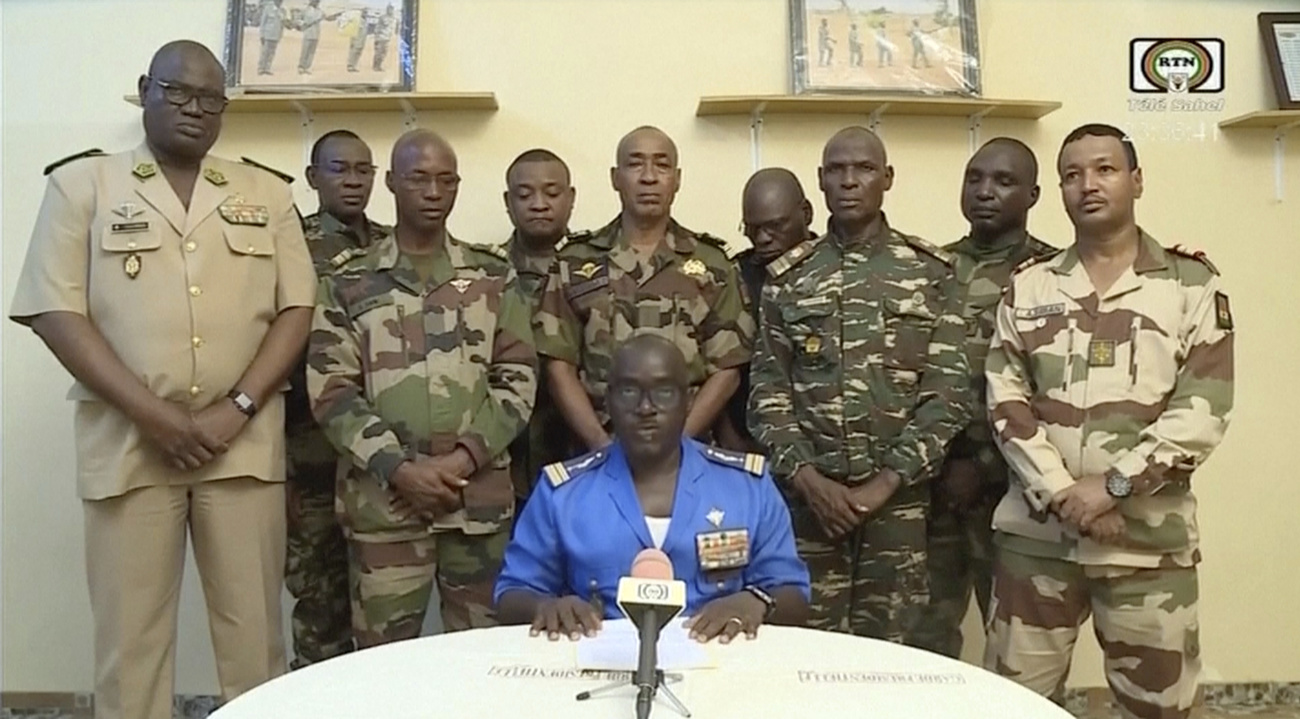 In this image taken from video provided by ORTN, Col. Maj. Amadou Abdramane, front center, makes a statement