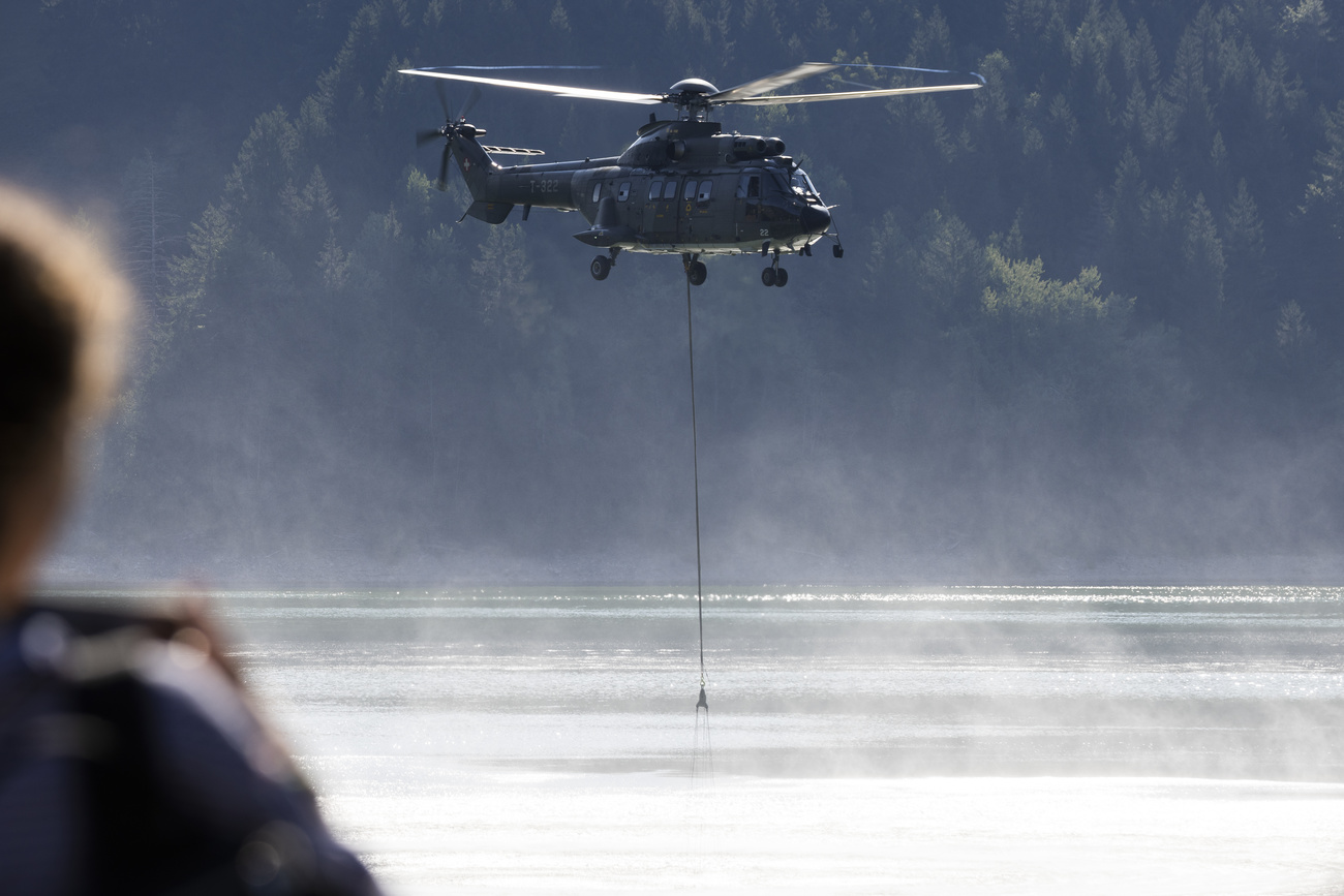Super Puma helicopter flying over a lake