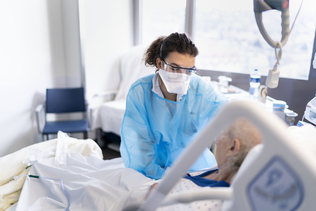 Nurse looks after patient in Swiss hospital.