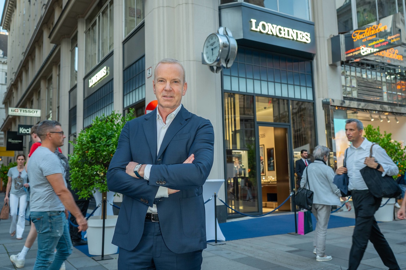 A shopper walks past the Swiss luxury watchmaker brand, Longines