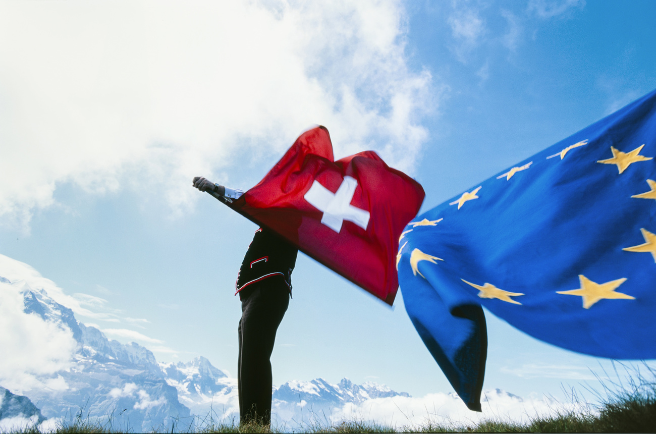 Swiss EU flags being thrown in air.