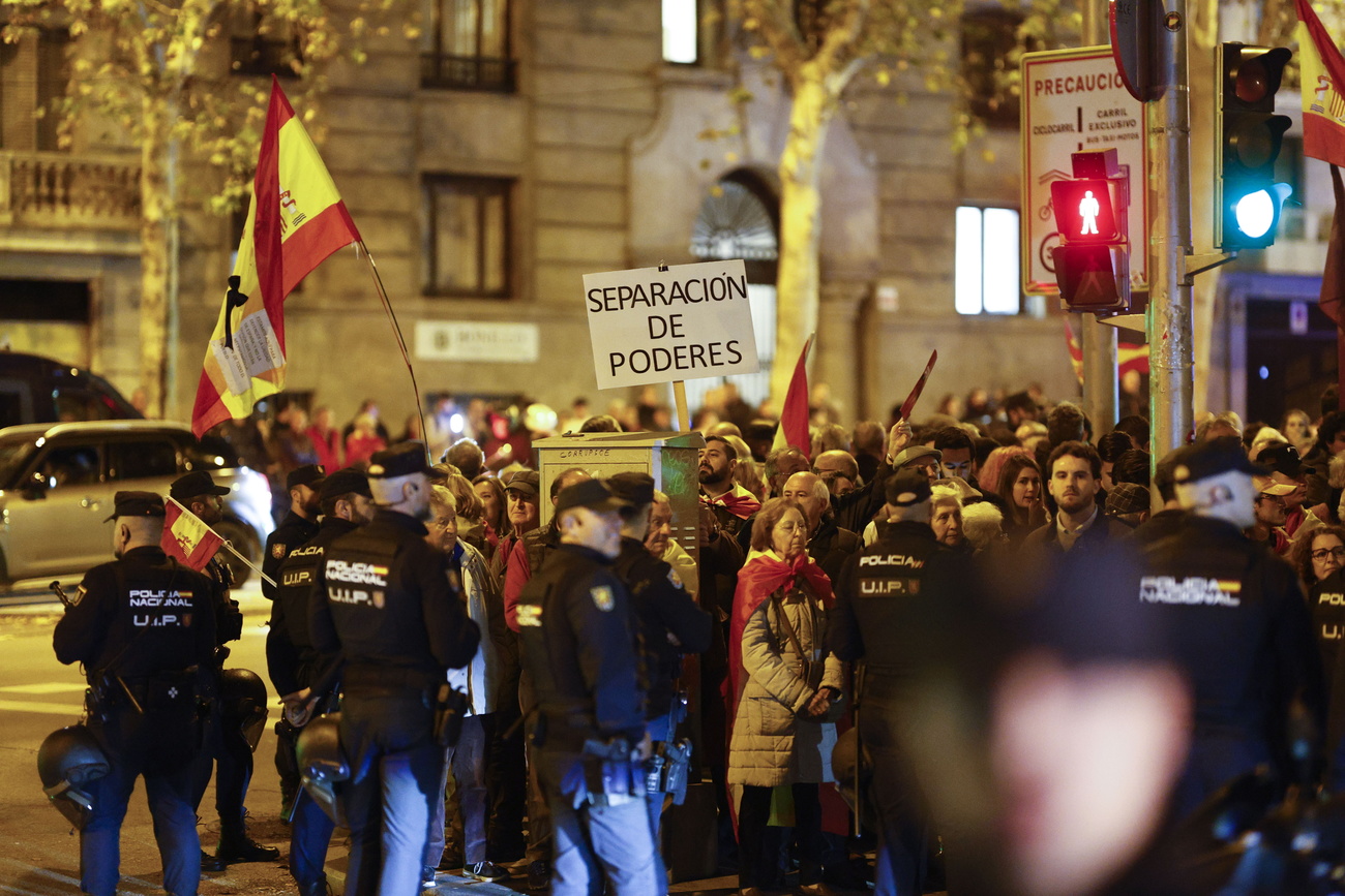 Picture of a protest in Spain with Spanish flags