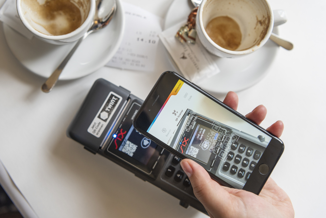 a mobile phone being used to pay a bill