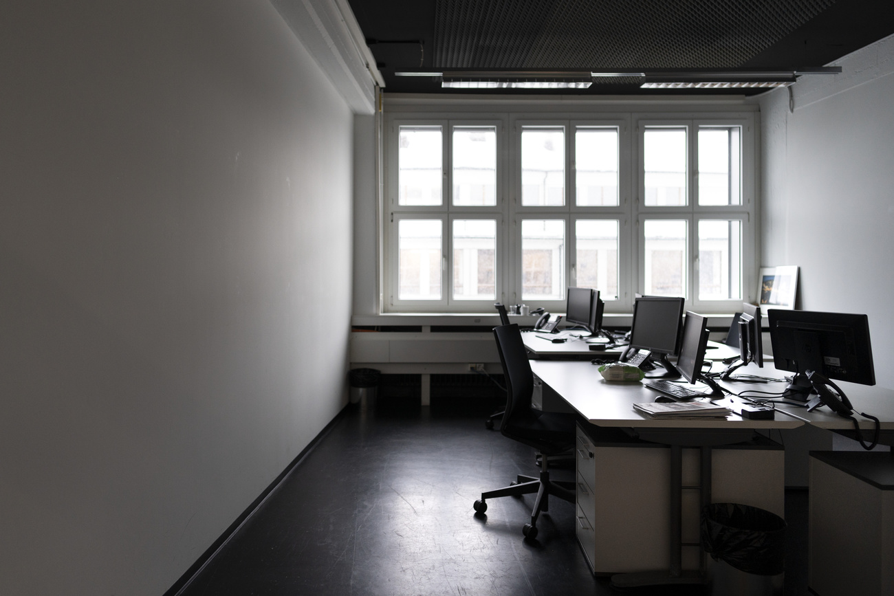 Picture of empty office with desk and computers