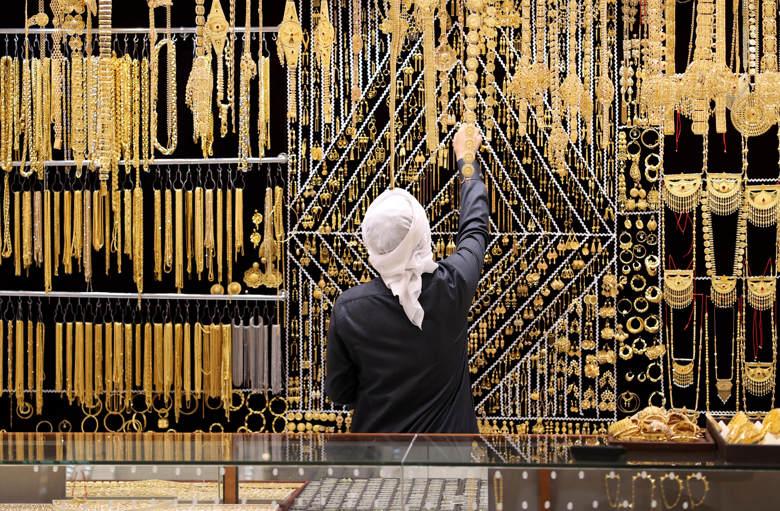 A salesman arranges gold jewelry at Dubai Gold Souk