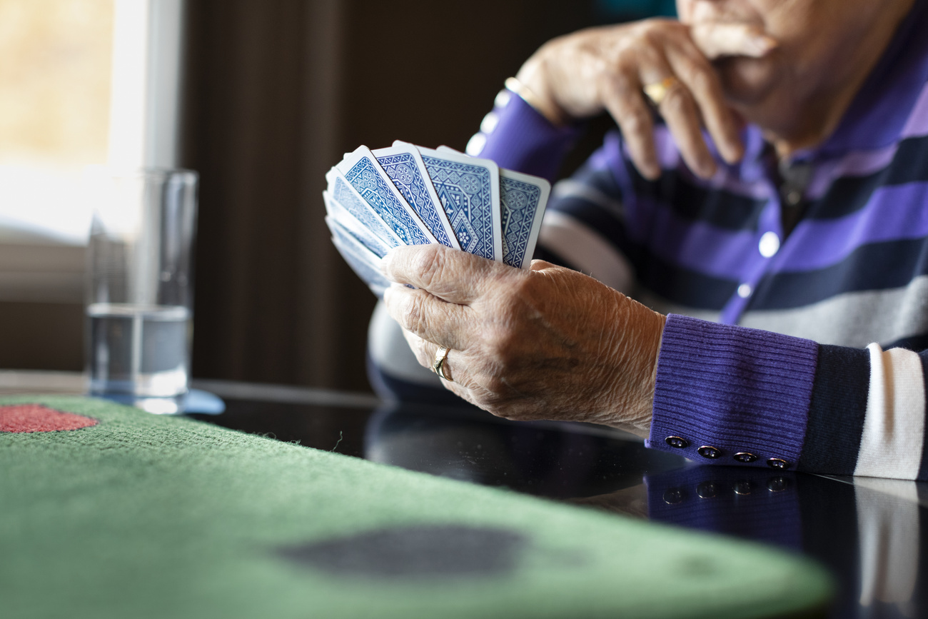 Elderly person playing cards in Switzerland