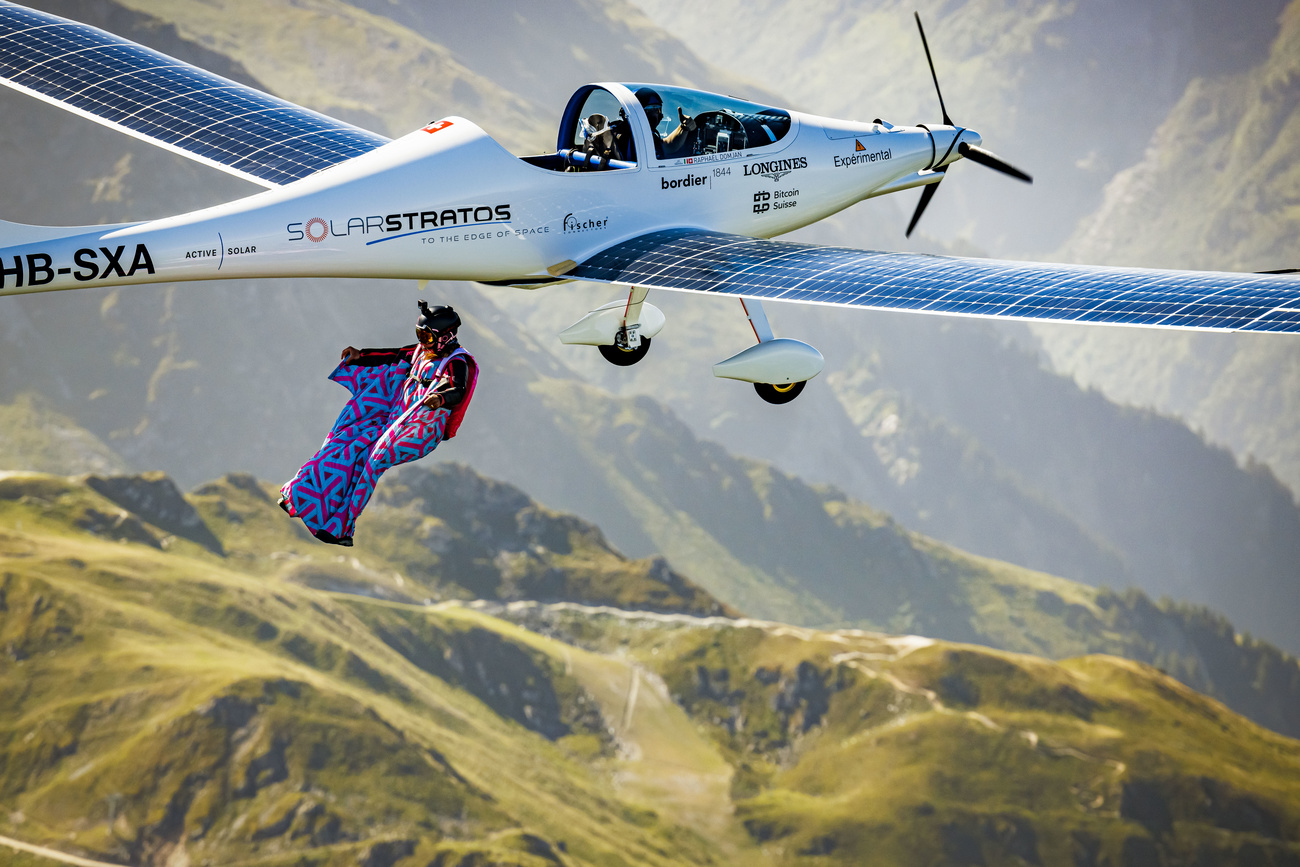 Swiss freeride snowboarder, base jumper and wingsuit pilot Geraldine Fasnacht jumps from SolarStratos, a solar-powered aircraft prototype flown by Swiss adventurer Raphael Domjan, to make the first wingsuit jump from an electric and solar aircraft over the Alpine resort of Verbier in Switzerland perform, Saturday, June 18, 2022.