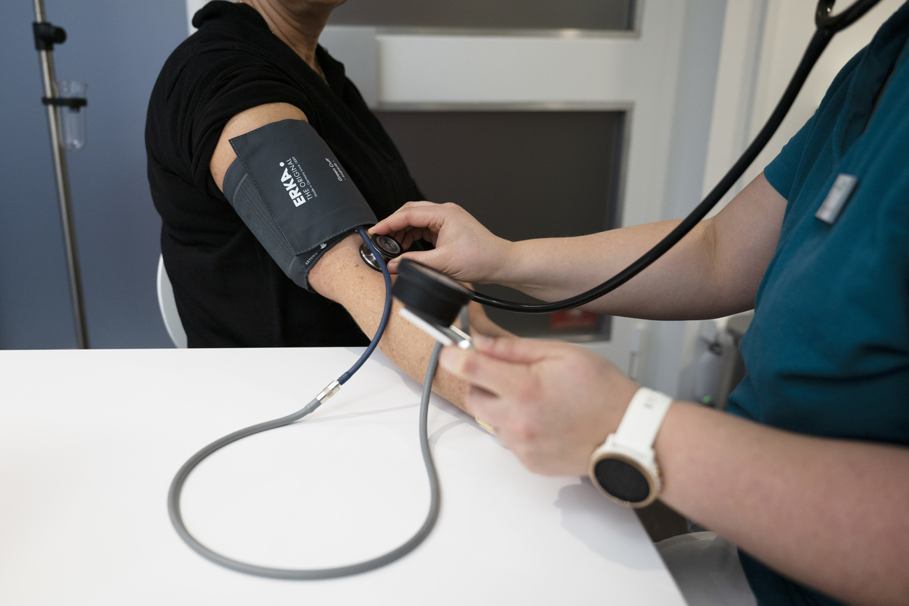 Person getting blood pressure checked.