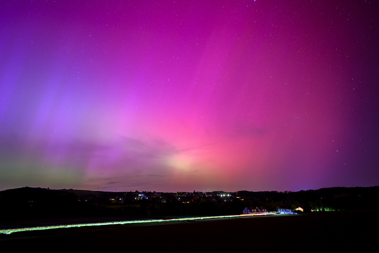 Aurora borealis over the village of Daillens, Switzerland, Saturday, May 11, 2024.