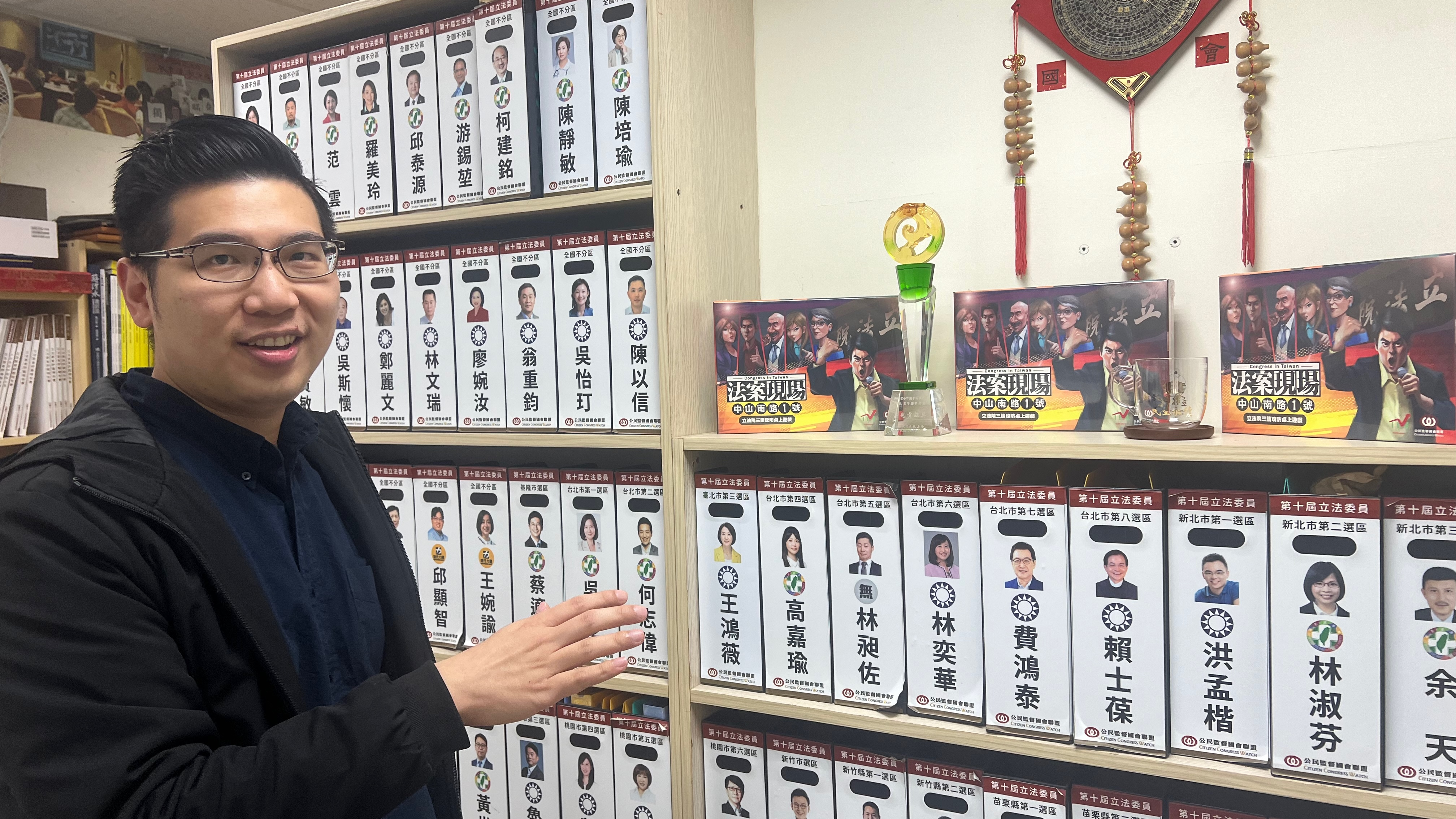 James Kan, Vice President of the organisation 'Citizens Congress Watch' in front of a bookcase with the files of selected candidates and elected politicians.