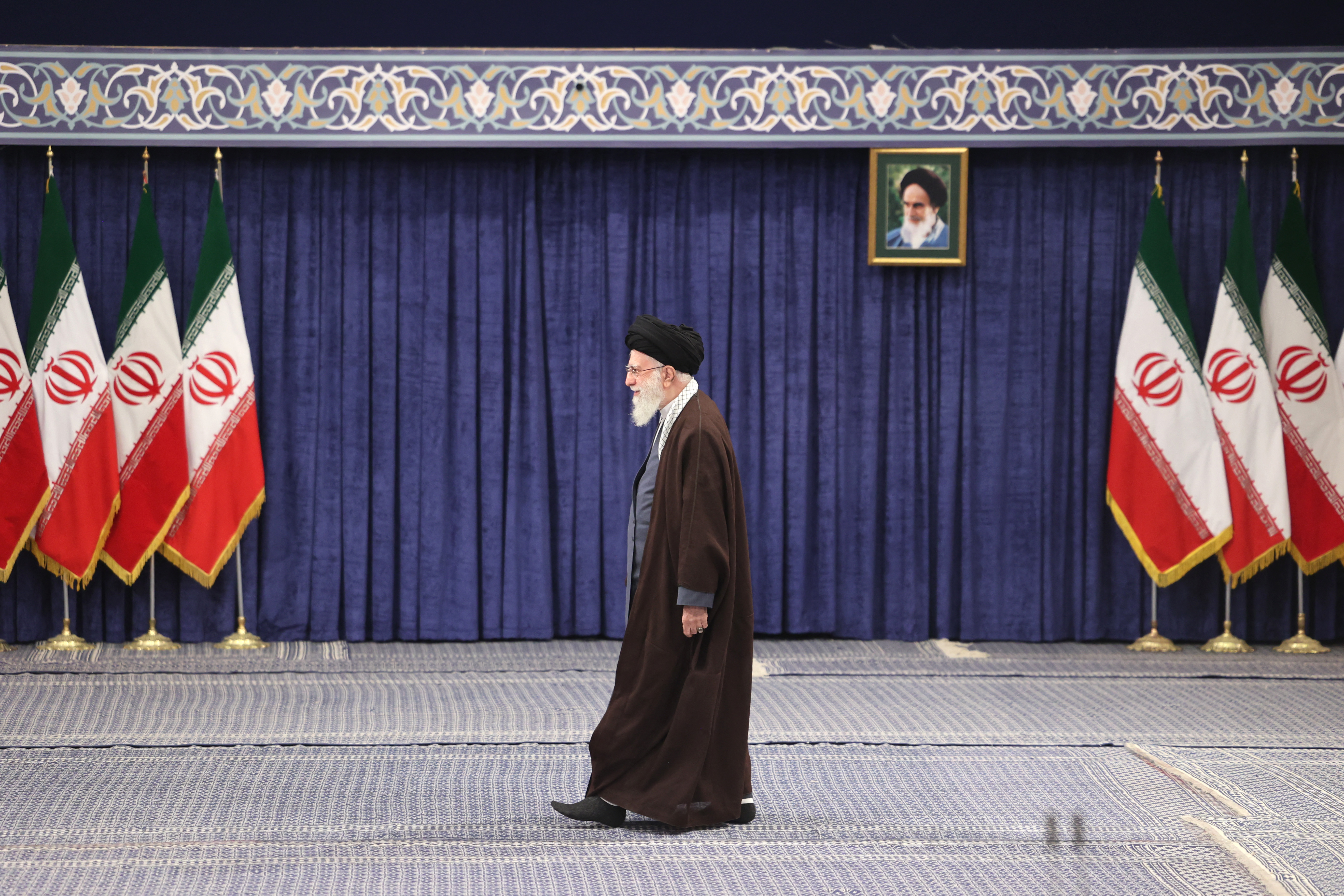 Ayatollah Ali Khamenei läuft über eine Bühne.