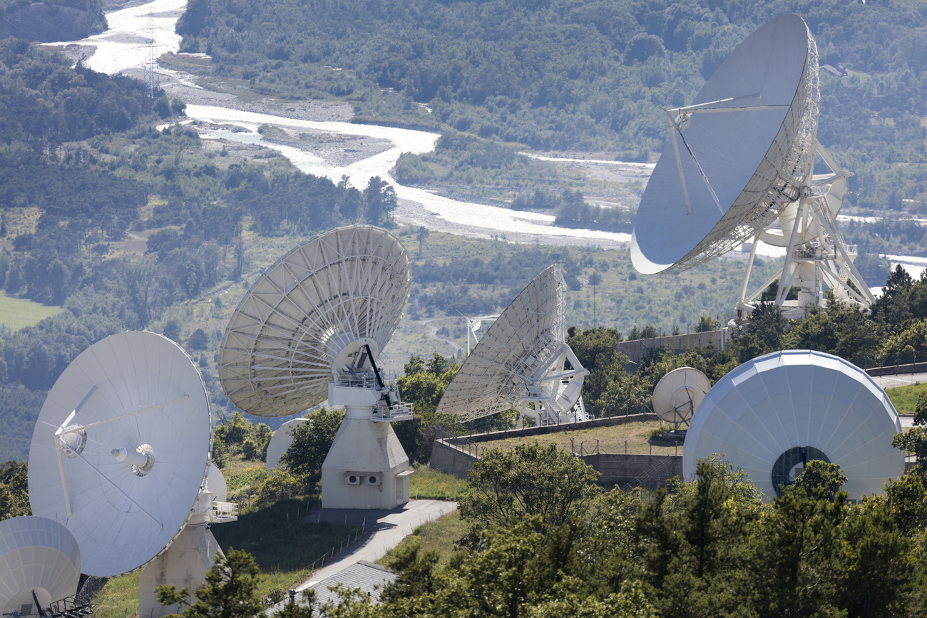 Parabolic antennas of the Brentjong satellite earth station above Leuk and the river Rhone in the canton of Valais, Switzerland.