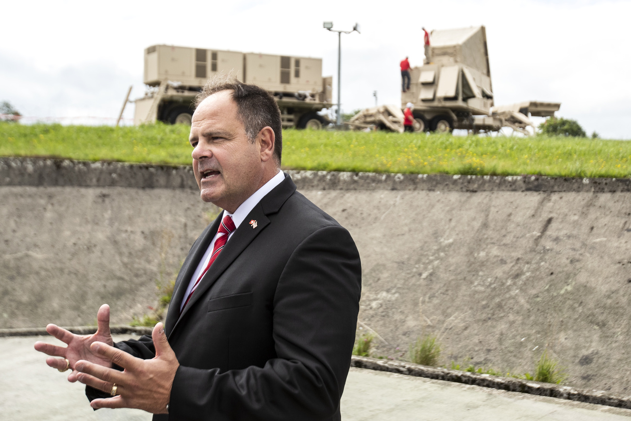 Joseph P. DeAntona, Vice President of Raytheon, speaks in front of the radar and power supply of the Patriot air defence system.