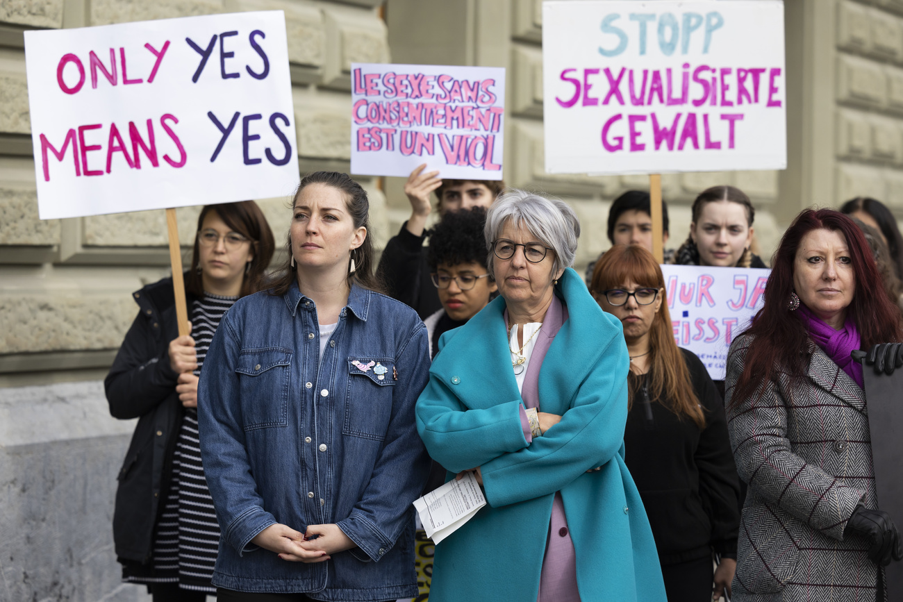 Leonore Porchet, National Councillor GP-VD, left, and Elisabeth Baume-Schneider, State Councillor SP-JU, stand together with supporters holding signs at the submission of signatures for the petition "Only yes means yes", on Monday, 21 November 2022 in Bern.
