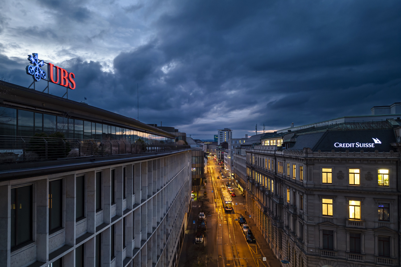 A view of the headquarters of UBS with its corporate logo, and across the street, the headquarters of Credit Suisse with its logo.