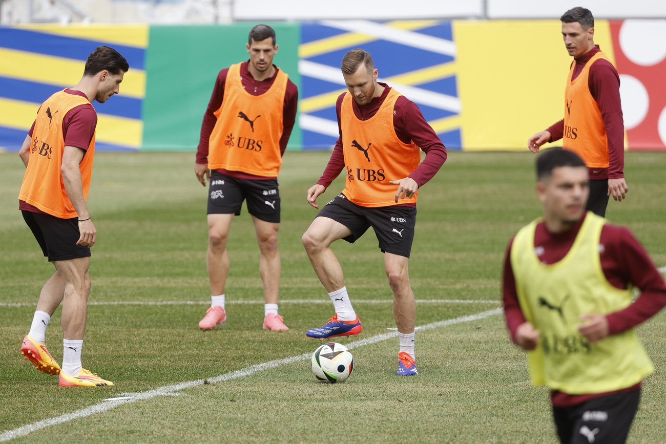 Swiss squad members warm up during a training session at the "Stadion auf der Waldau" in Stuttgart, Germany, on June 12, 2024.