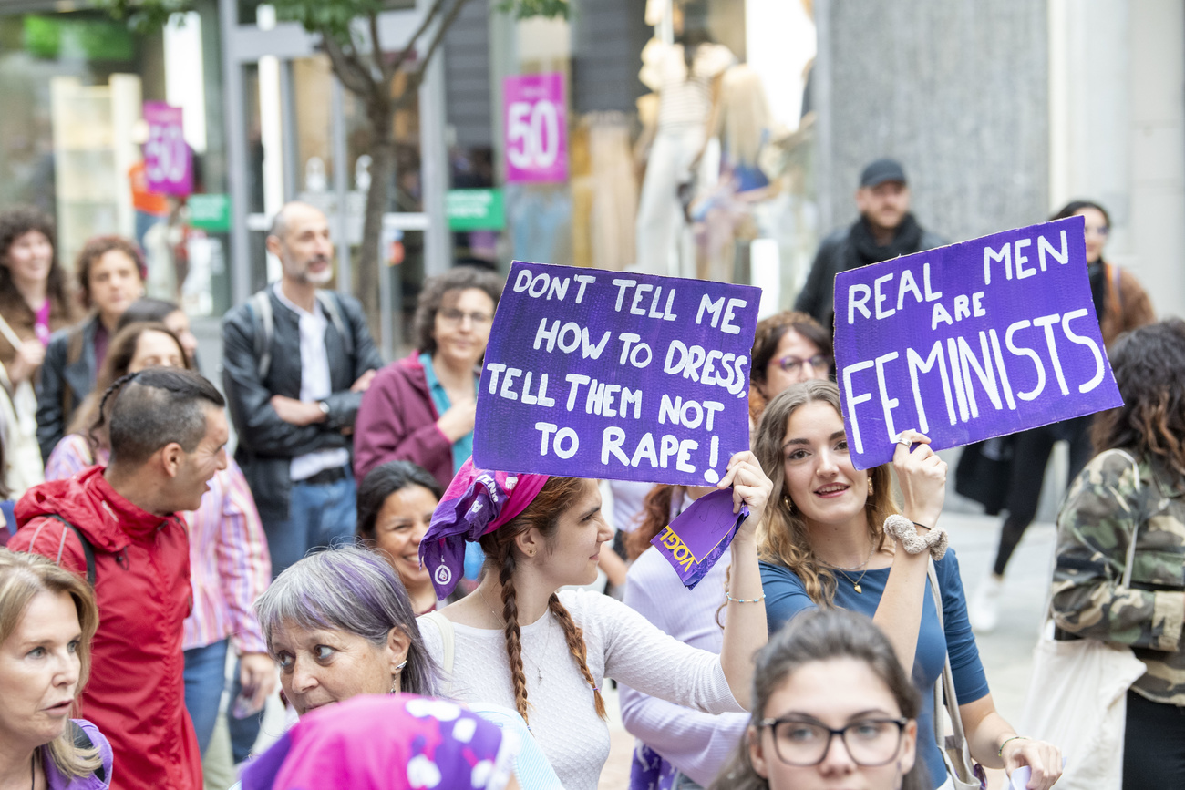 Many people demonstrate at the Feminist Strike on Friday, 14 June 2024 in Bellinzona. Visible are two hand made purple signs.