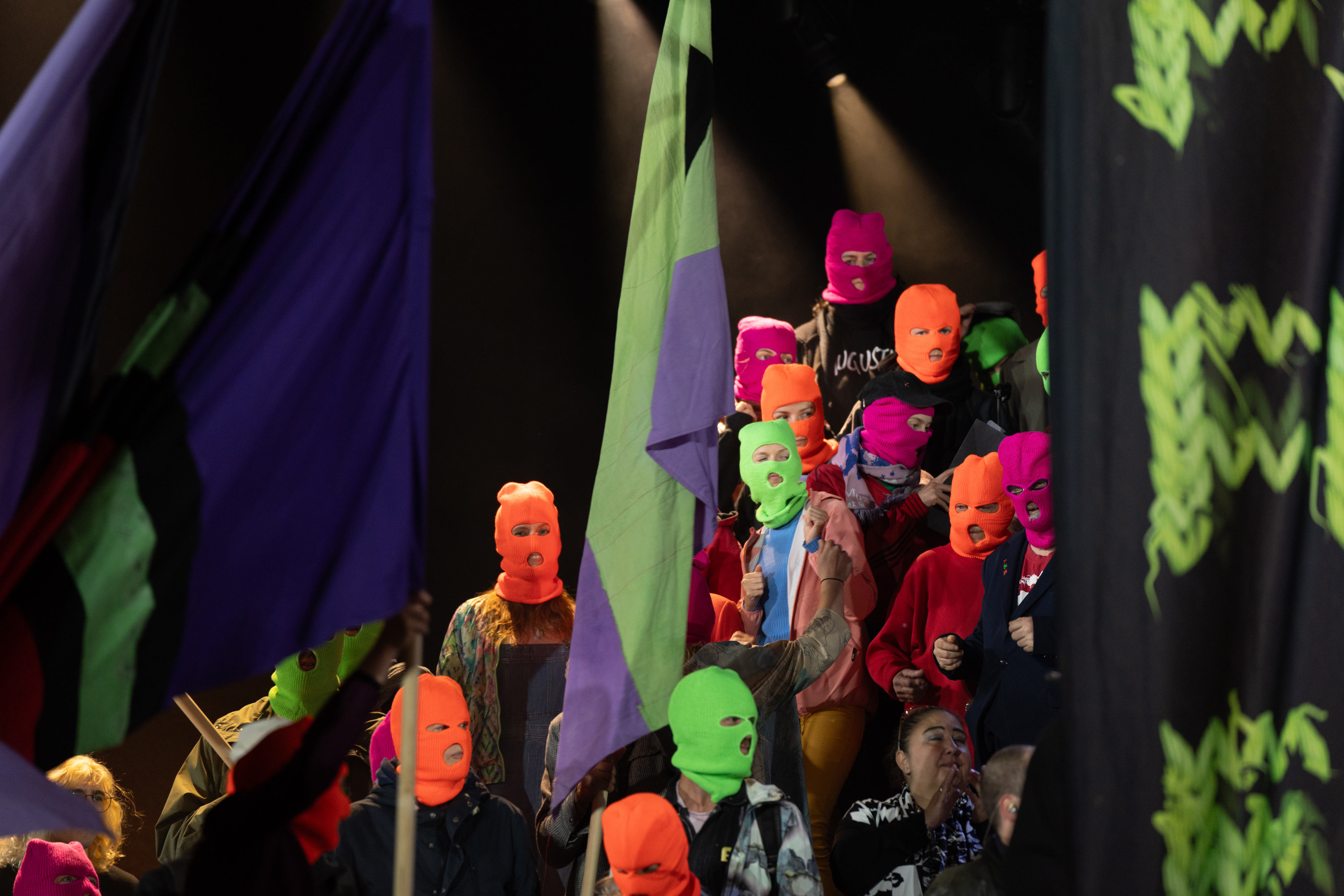 Masked people on stage