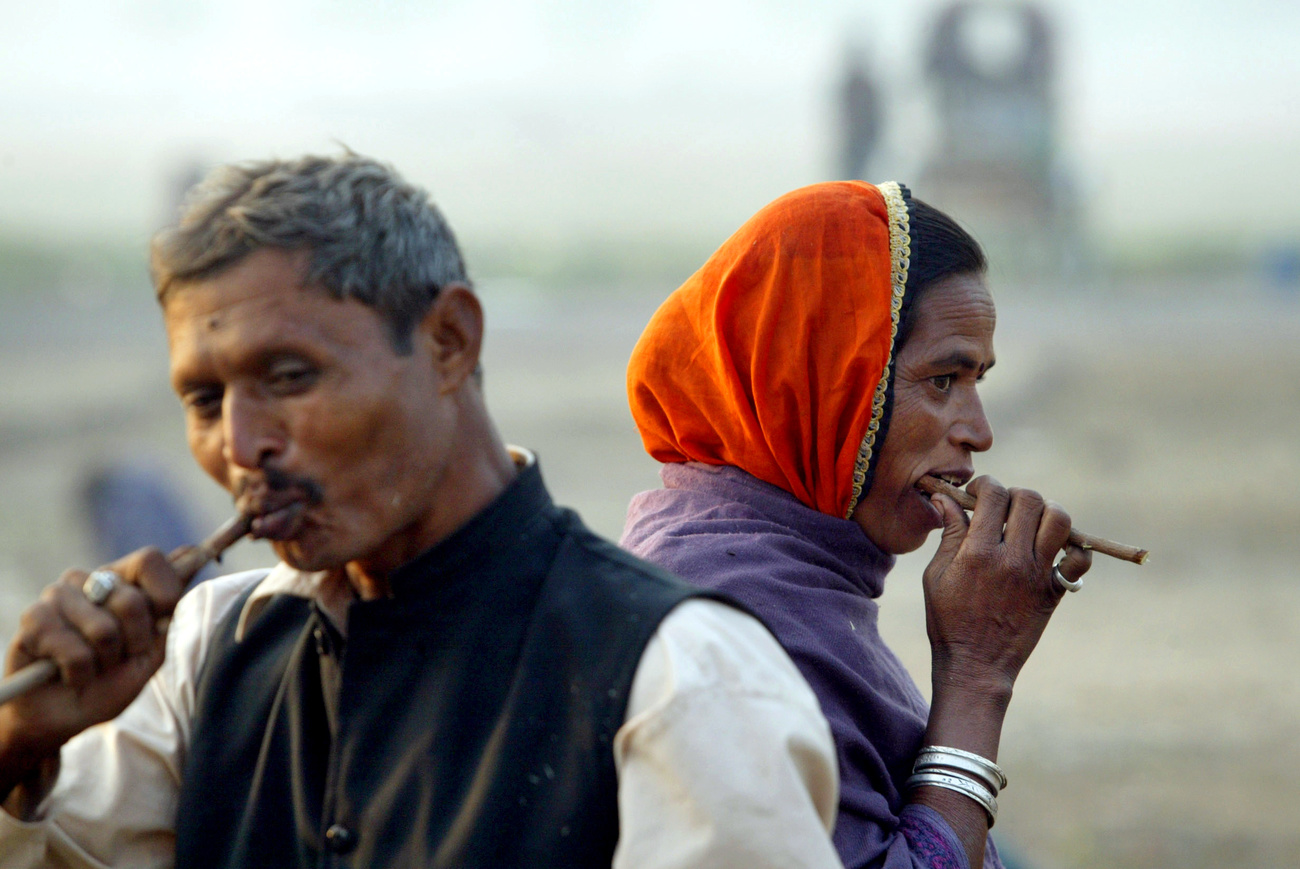 Two people washing their teeth