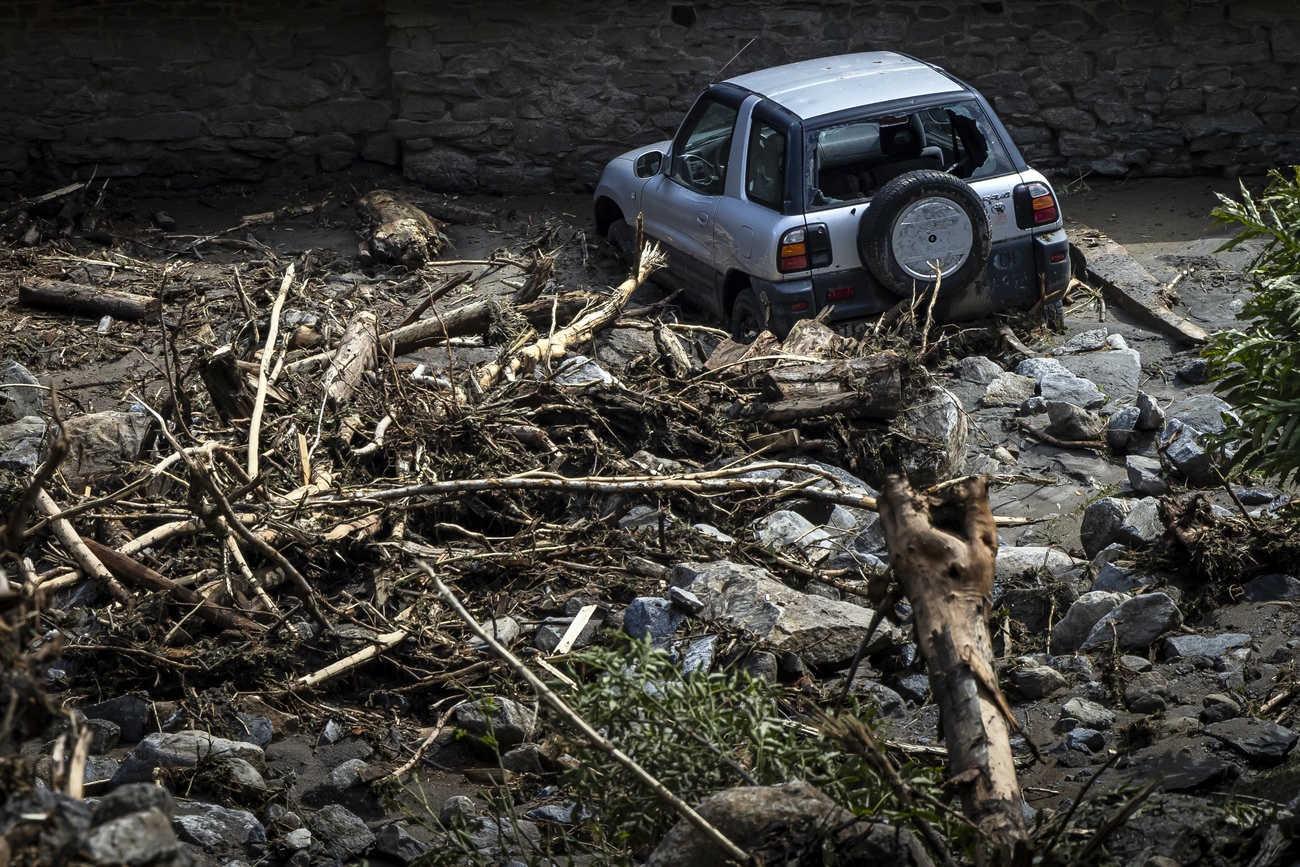 A destroyed car in the debris in Fontana, Val Bavona, in the Maggia Valley, near Cevio, southern Switzerland