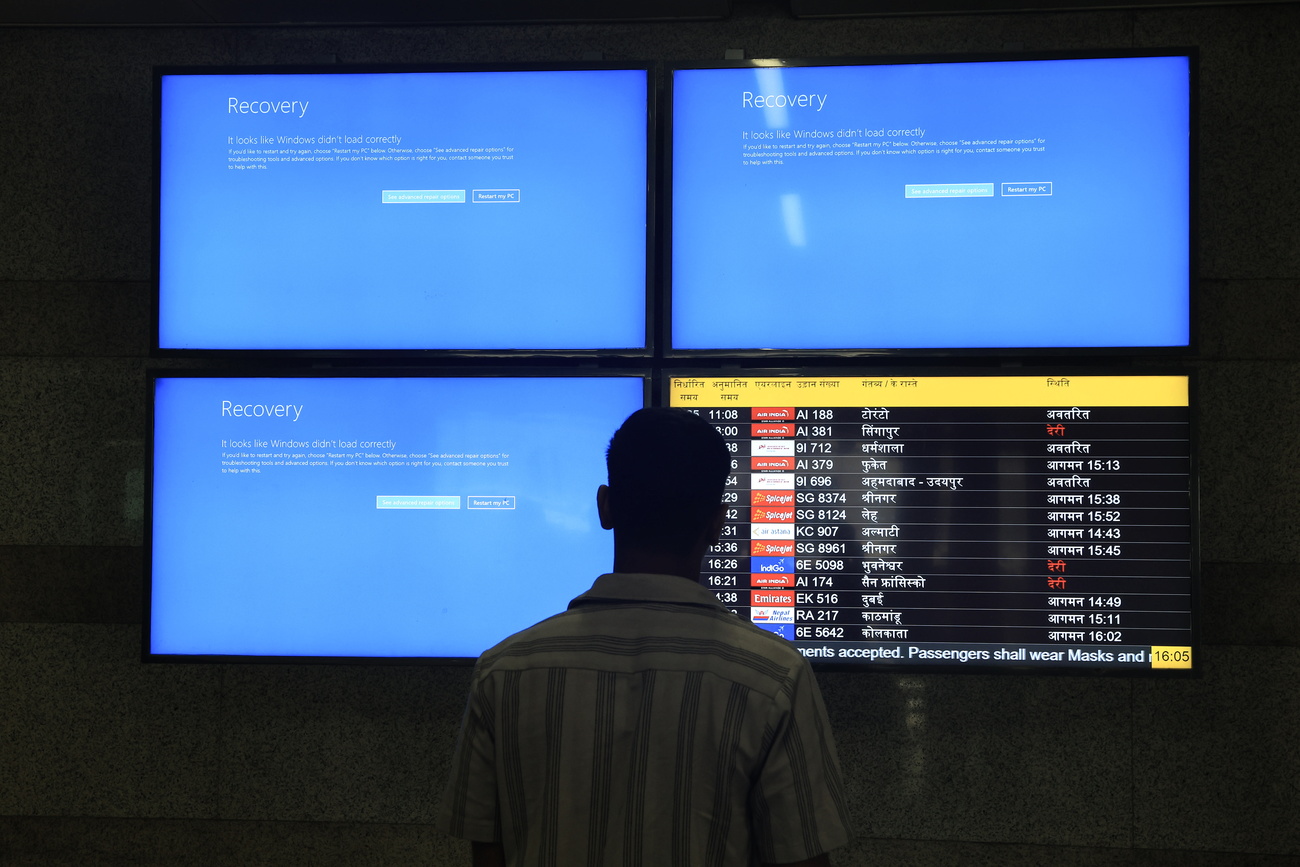 a man looking at 3 blue error screens and only 1 functional airline schedule list