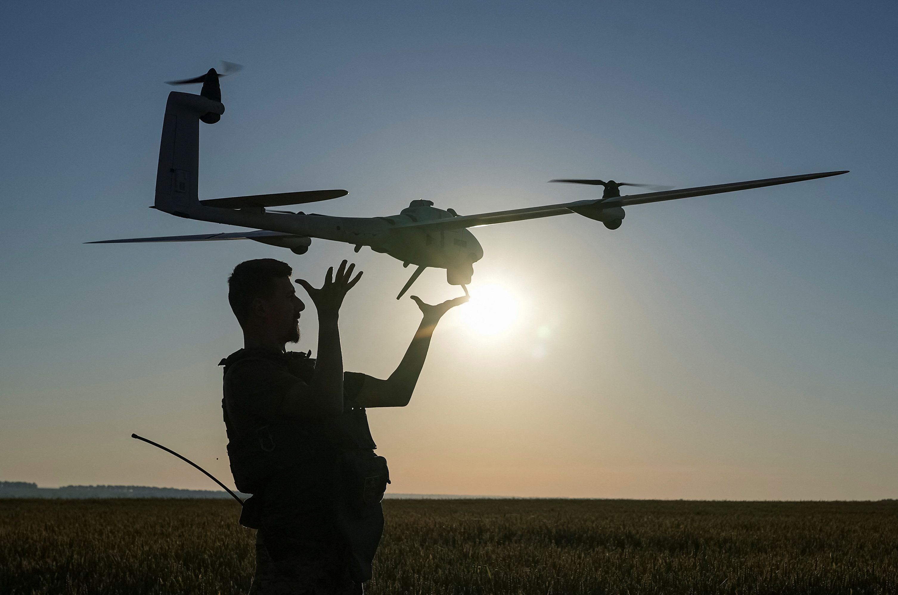 A Ukrainian serviceman launches a mid-range reconnaissance type drone to fly over positions of Russian troops in the Kharkiv region, Ukraine June 19, 2024.