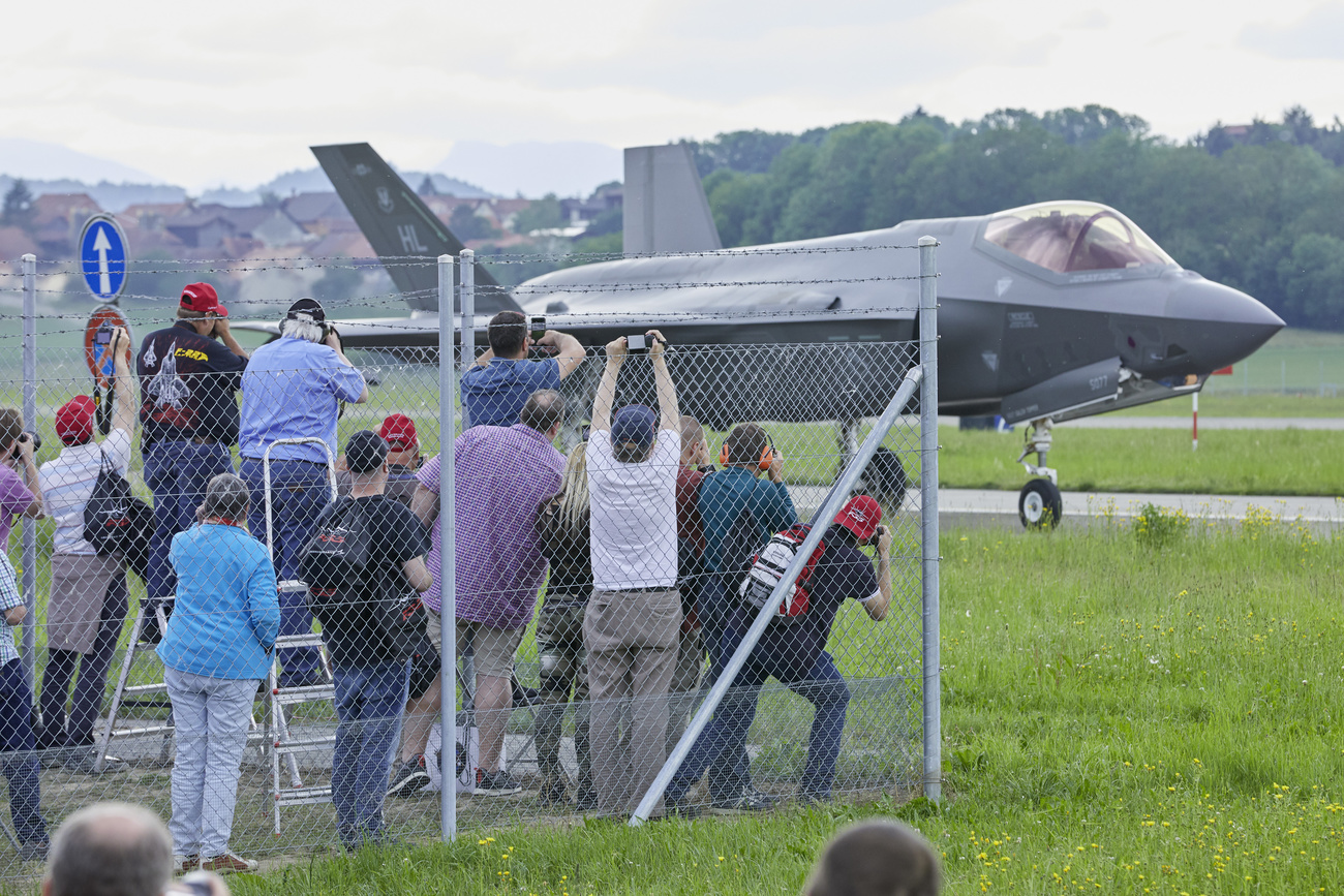 Curious onlookers photograph an F-35 jet during a demonstration in Switzerland.