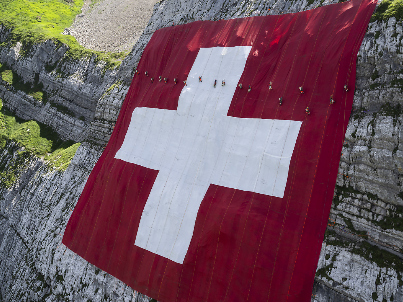 The largest Swiss flag hangs on the Säntis