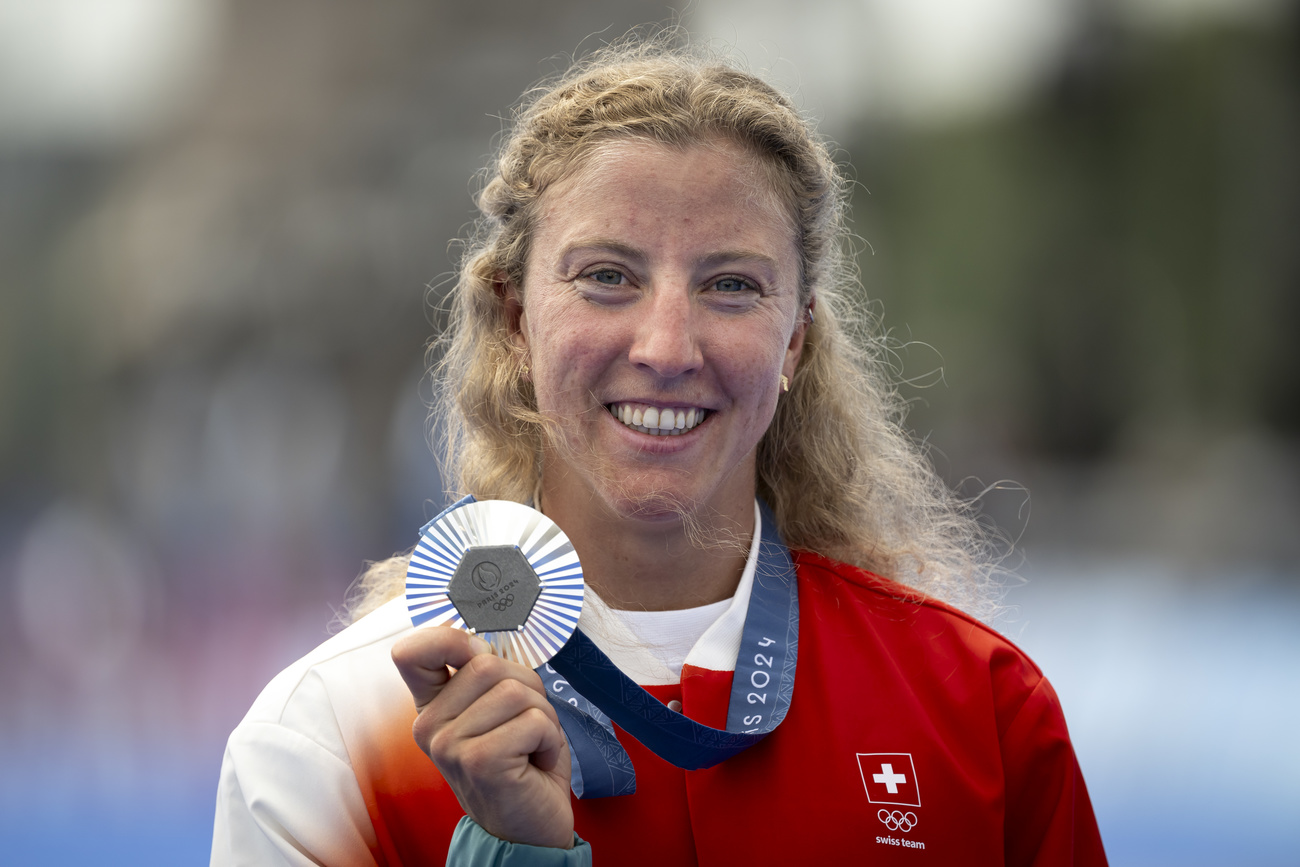 Silver medallist Julie Derron of Switzerland celebrates after the medal ceremony for the women's triathlon competition at the 2024 Paris Summer Olympics in Paris, France, Wednesday, July 31, 2024. (KEYSTONE/Anthony Anex)