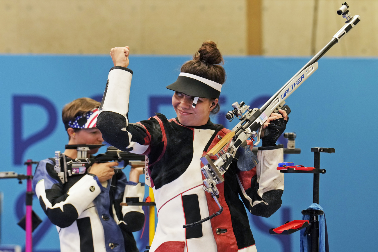 Switzerland's Chiara Leone, right, reacts after winning the gold medal in the 50m rifle 3 positions women's final competition at the 2024 Summer Olympics, Friday, Aug. 2, 2024, in Chateauroux, France. (AP Photo/Manish Swarup).TEST