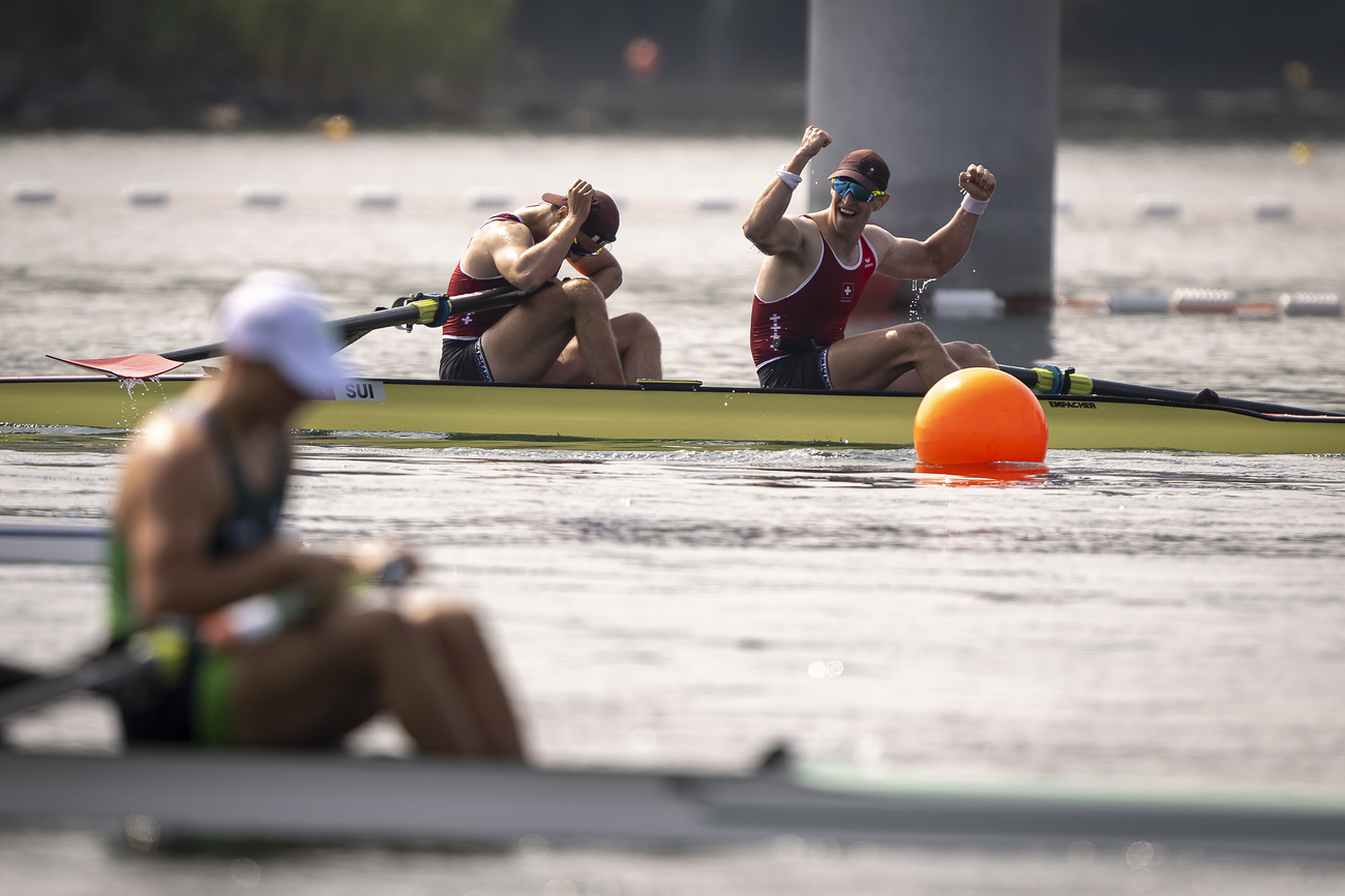 Bronze medallists Roman Roeoesli and Andrin Gulich of Switzerland celebrate their victory after crossing the finish line, during the men's rowing Pair Final A at the 2024 Paris Summer Olympics in Vaires-Sur-Marne, France, Friday, August 2, 2024. (KEYSTONE/Anthony Anex)