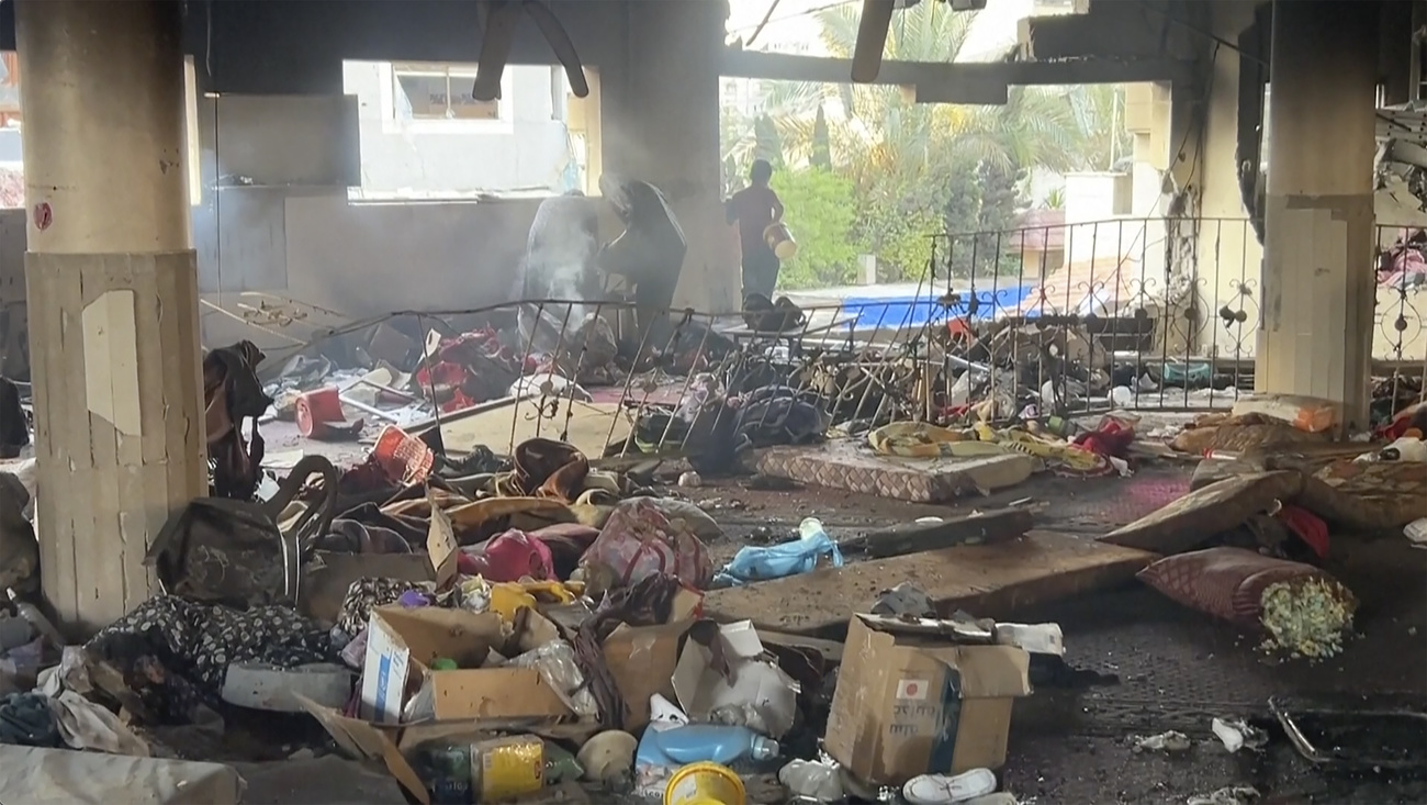 In this image from video, people examine the rubble of a school after it was hit by an Israeli airstrike in Gaza City, Saturday, August 10, 2024.