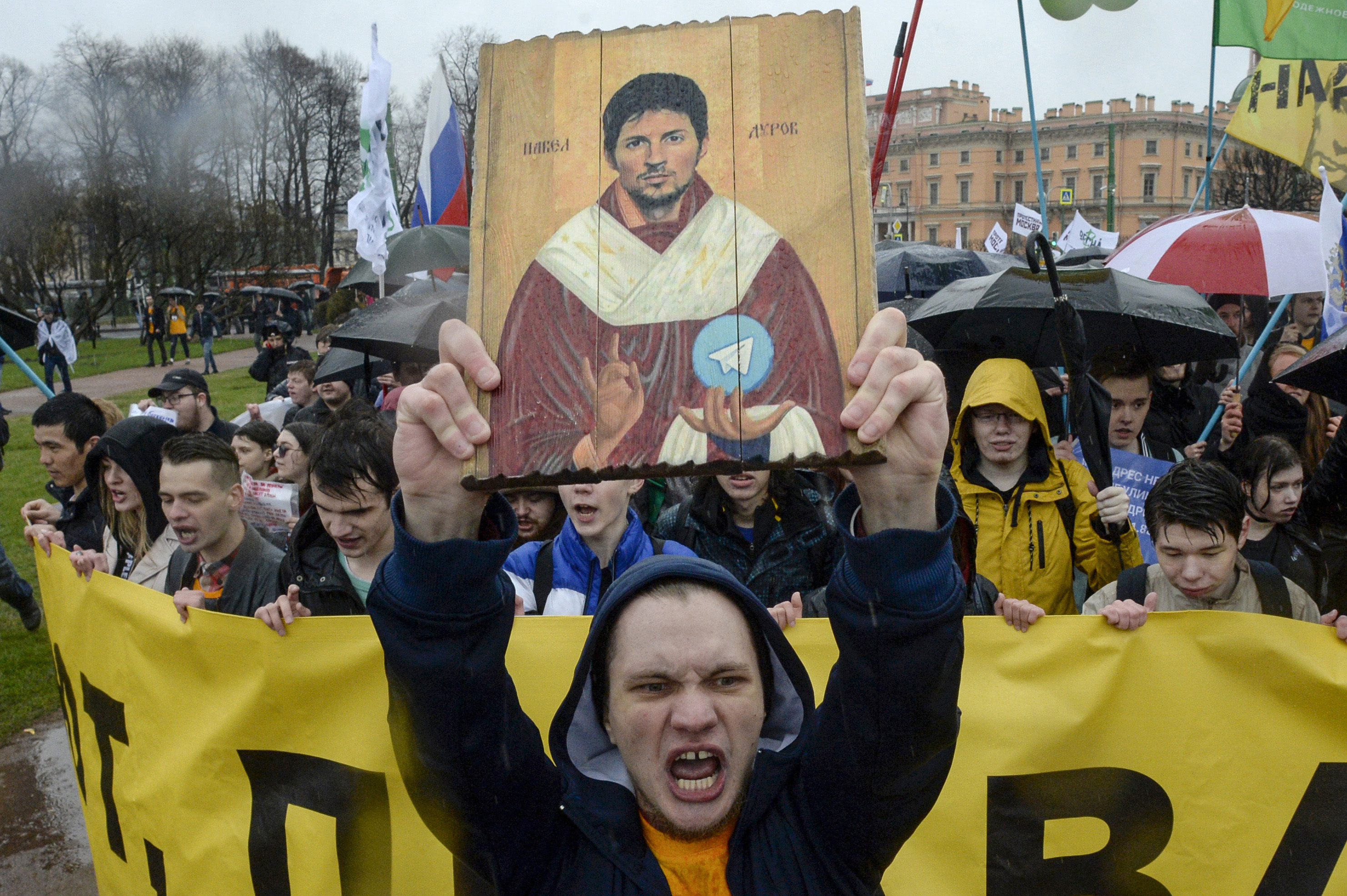 A man holding up an icon