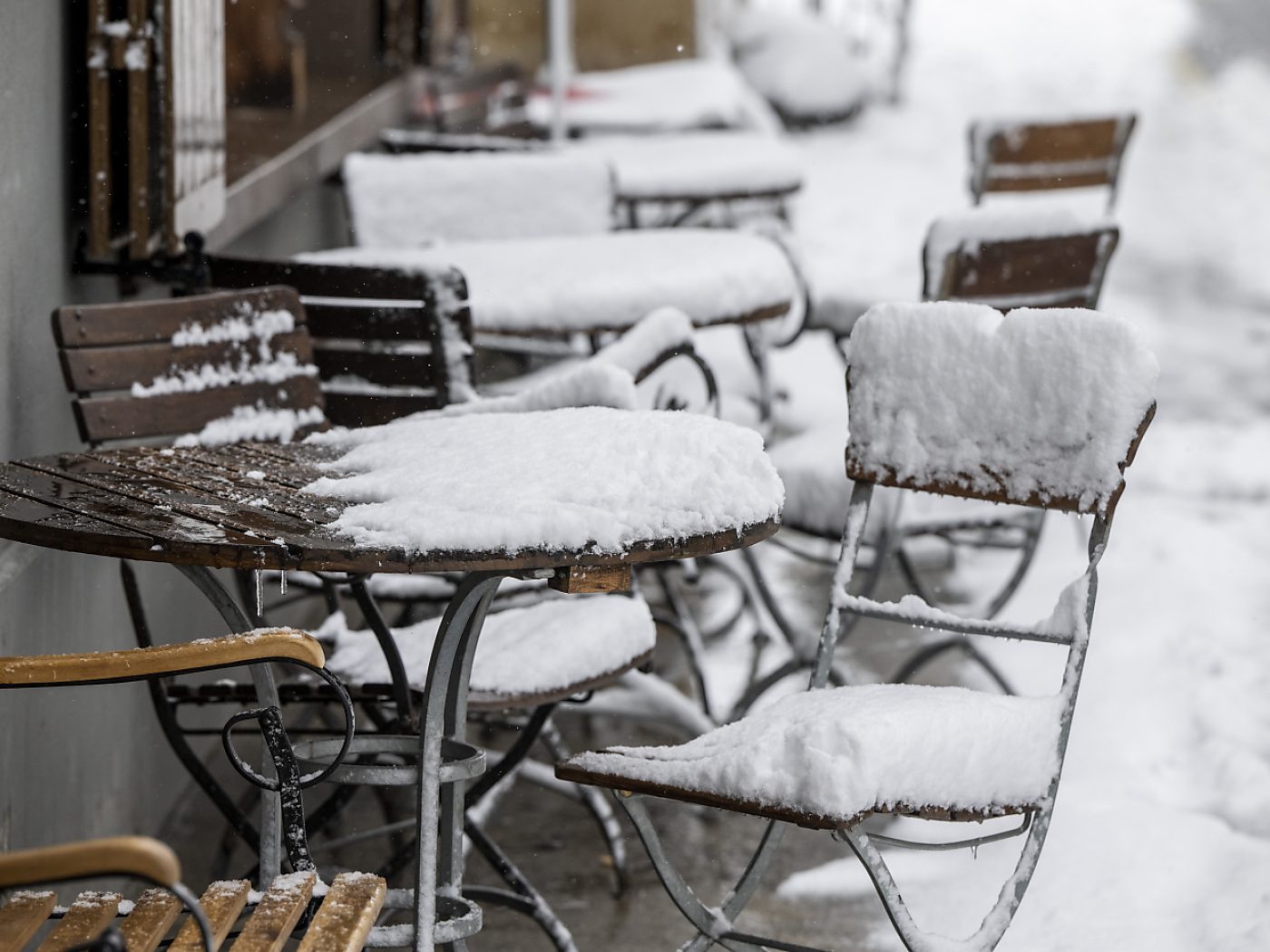 Outdoor chairs covered in snow