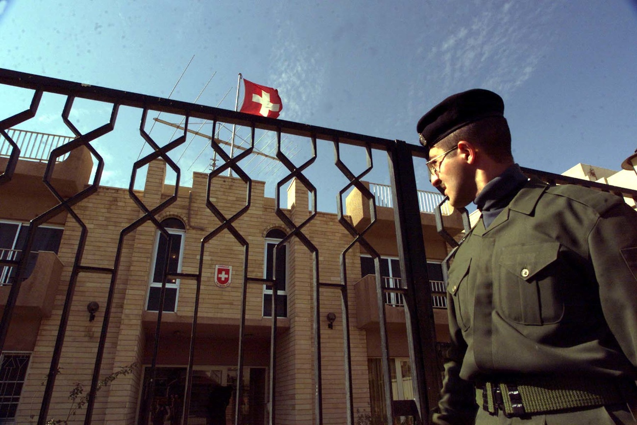 An unidentified Iraqi police guard on Friday, February 2, 2001, standing outside the Swiss embassy in Baghdad which was reopened Thursday, February 1. Switzerland never severed diplomatic ties with Iraq, but closed it's embassy for security reasons during the Gulf war. (KEYSTONE/AP Photo/Jassim Mohammed)