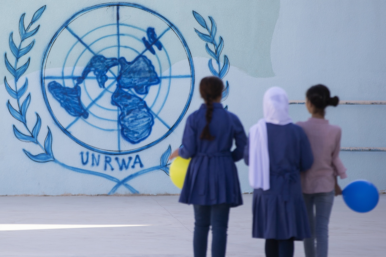 three girls infront of a UNRAW sign