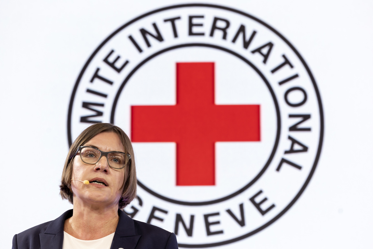 PRESIDENT OF THE ICRC SEEN IN FRONT OF RED CROSS LOGO