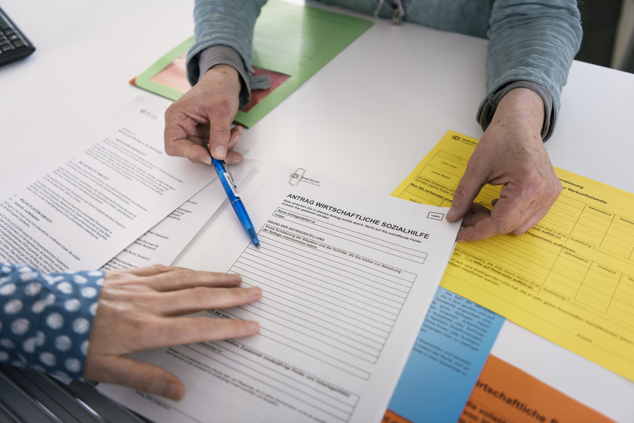 paper work and hands pointing at the paper work